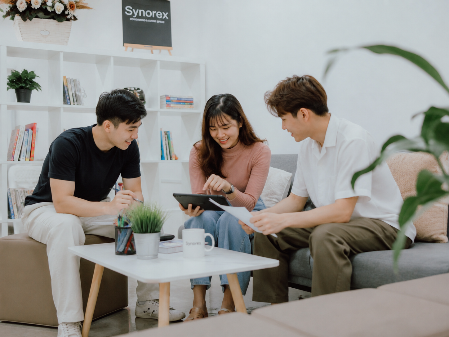 Synorex team reviewing work together in the lounge