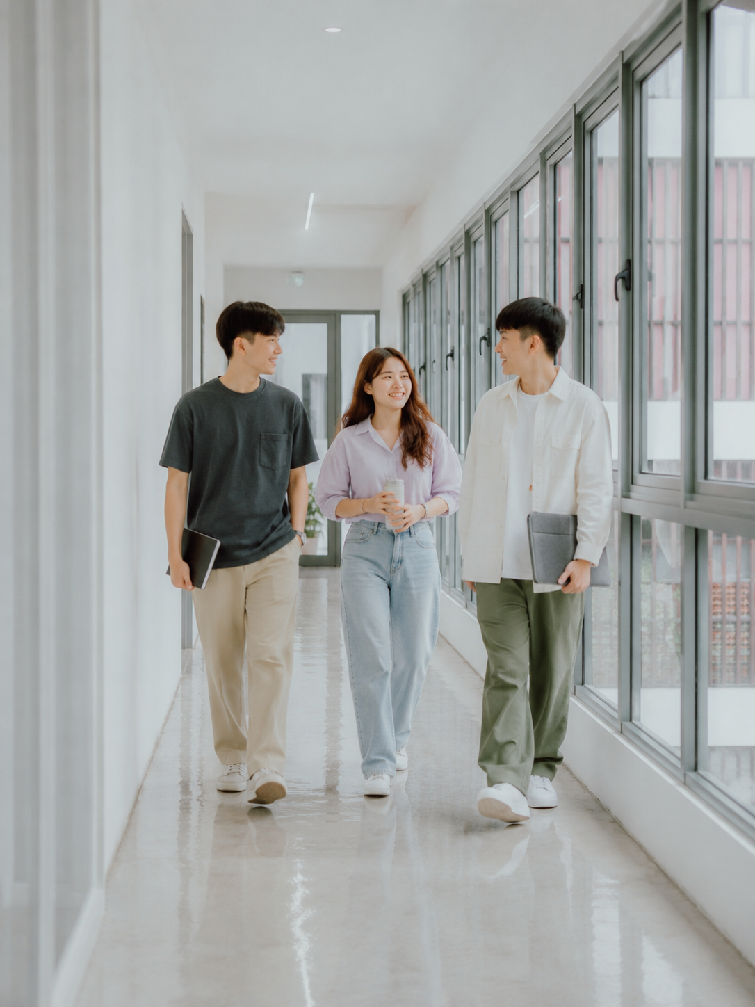 Synorex team walking through a bright office corridor