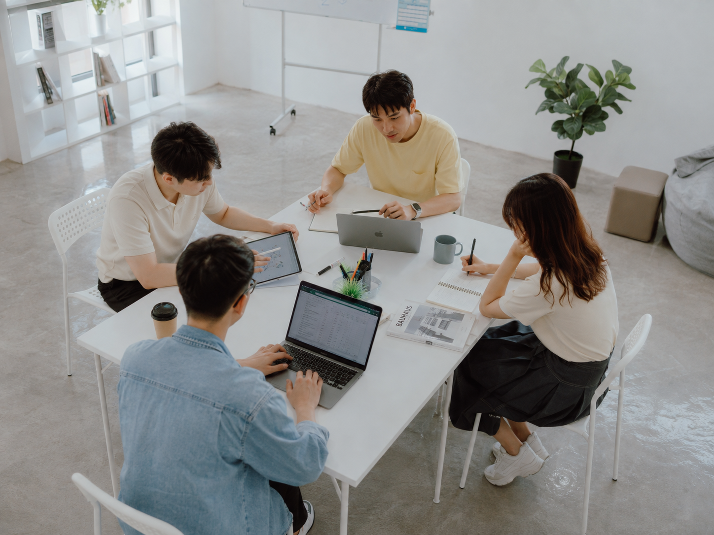 Synorex team working around a shared office table
