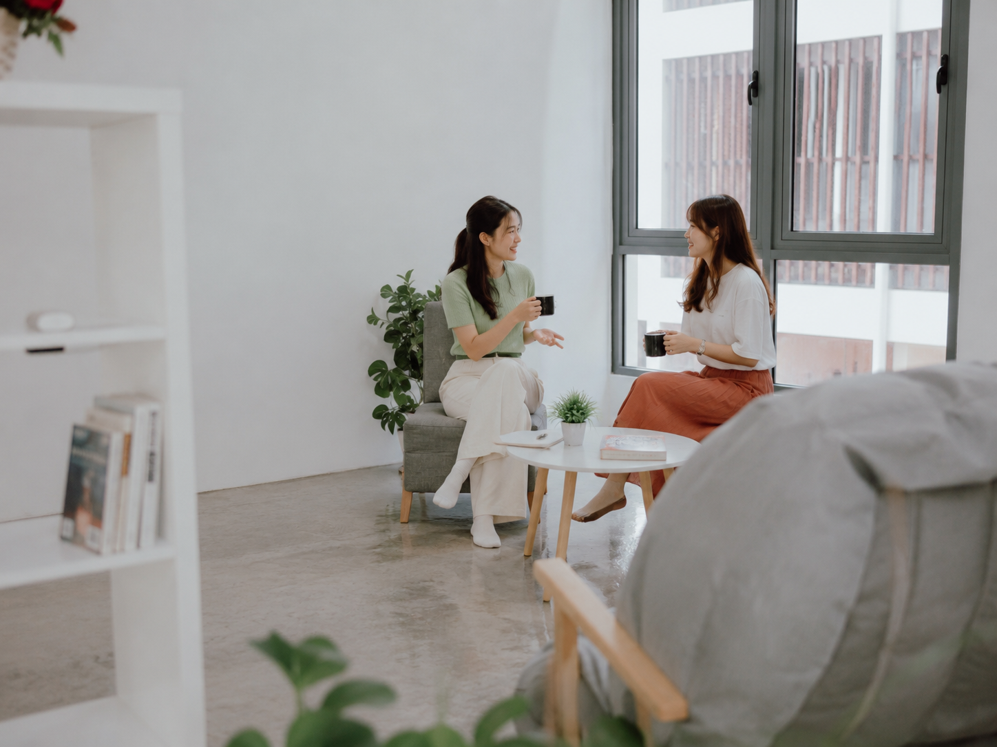 Synorex team members talking over coffee in the office lounge